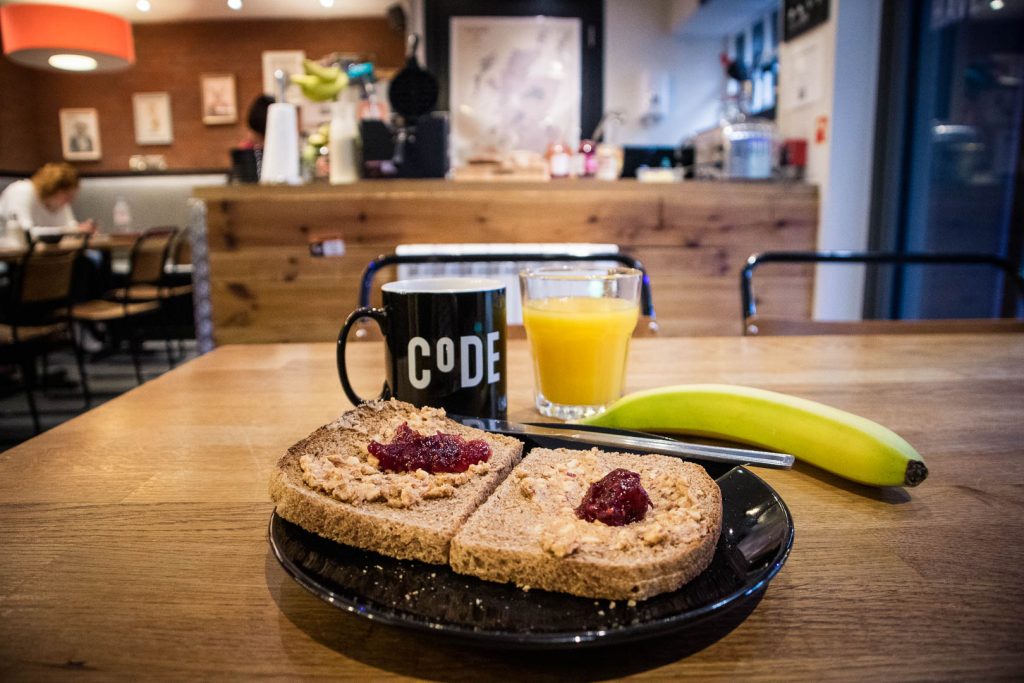 Toast with peanut butter, orange juice and a banana for breakfast at Code pod hostel in Edinburgh