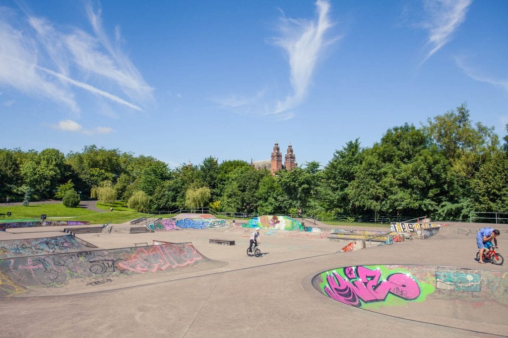 A skate park at Kelvingrove Park with Kelvingrove Museum and Art Gallery in the background.