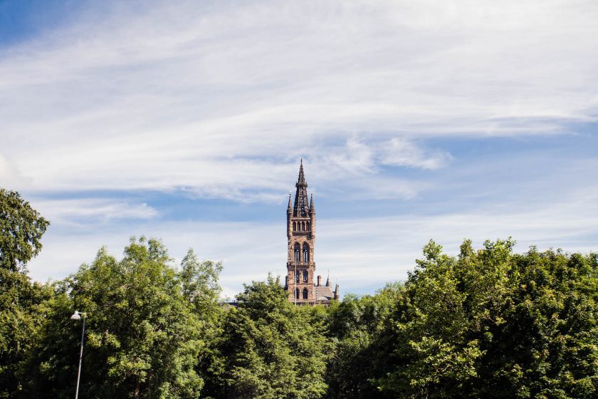 Bell tower of Glasgow University peeking out above the trees