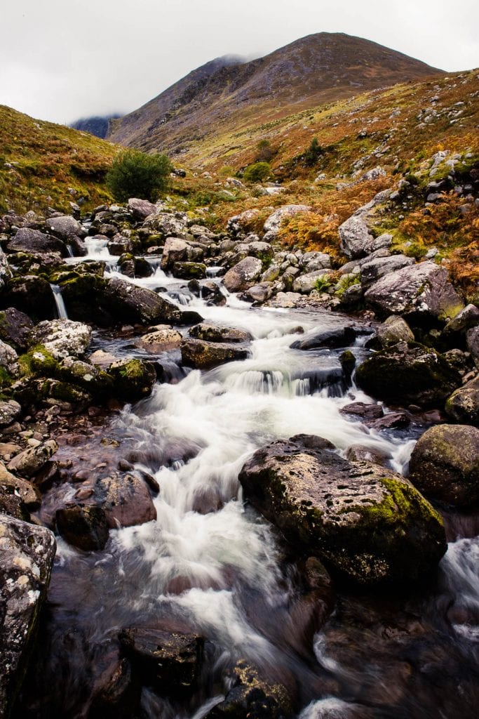 This is a hiking guide about how to climb Carrauntoohil, the highest mountain in Ireland, with different hiking trails up Carrauntoohil and what to pack!