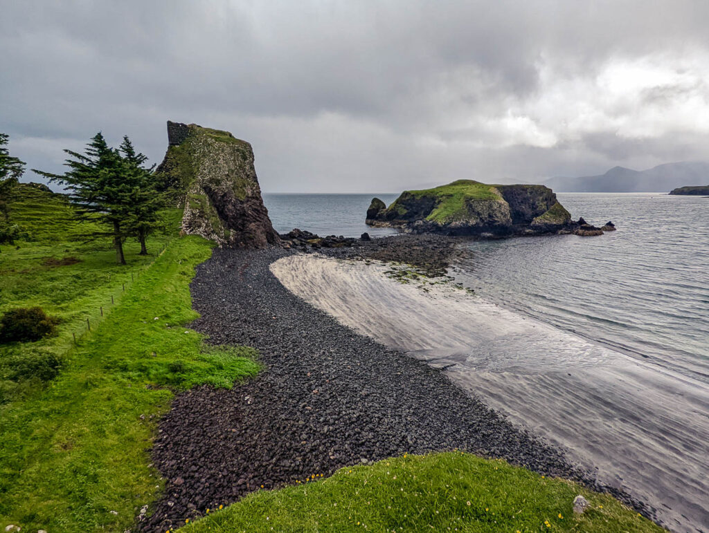 Black beach and Coroghan Castle on the Isle of Canna