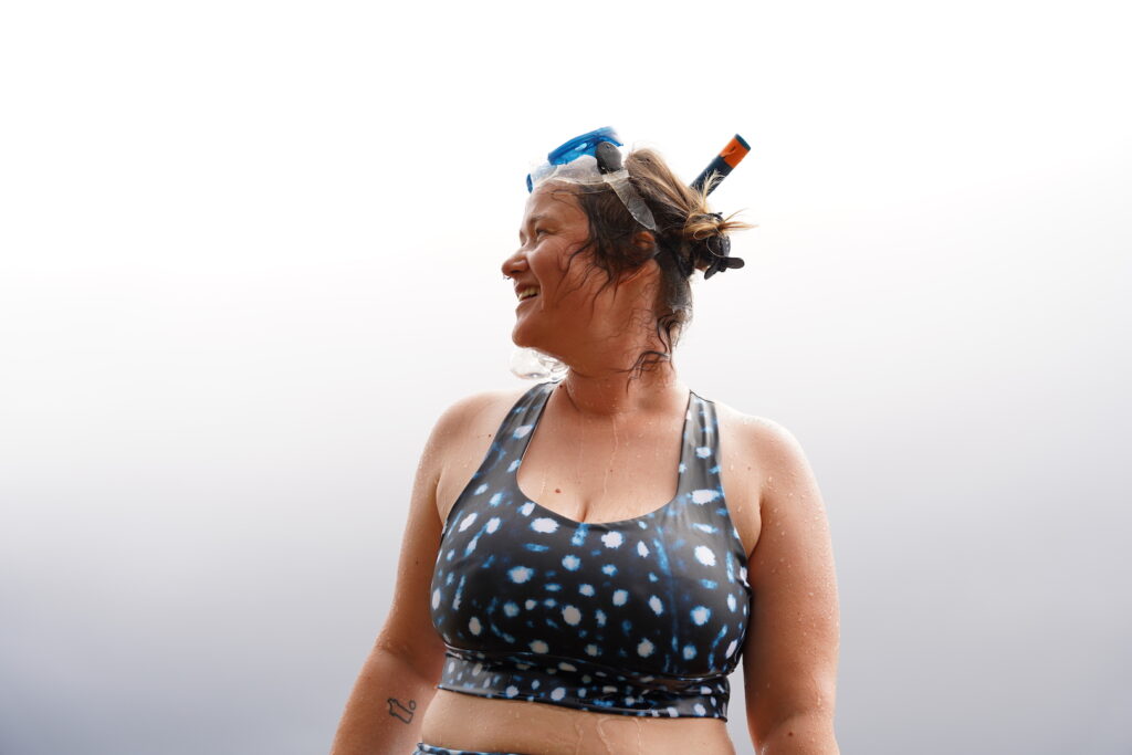 a woman in snorkel equipment and a patterned bikini top