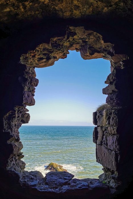 Sea view through a stone window at Dunnottar Castle in Scotland