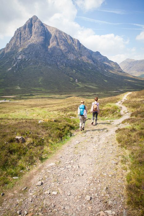 Two women hiking towards Buachaille Etive Mor in Scotland